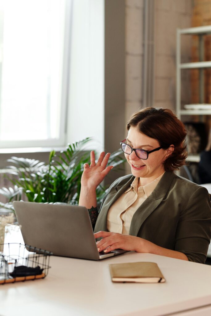 pexels-photo-4064176-4064176 Businesswoman in glasses on a video call in a stylish office setting.